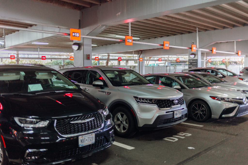 A row of cars parked in a parking garage